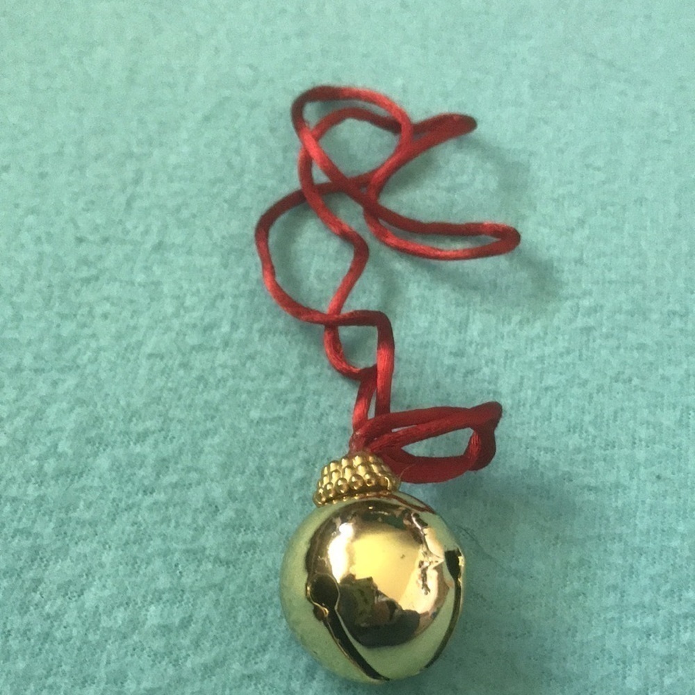 GOLD COLORED BELL on a red silky rope necklace